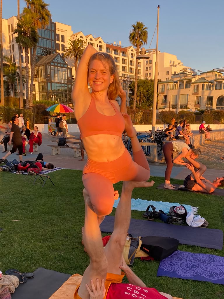 Shayna practicing acro yoga at sunset